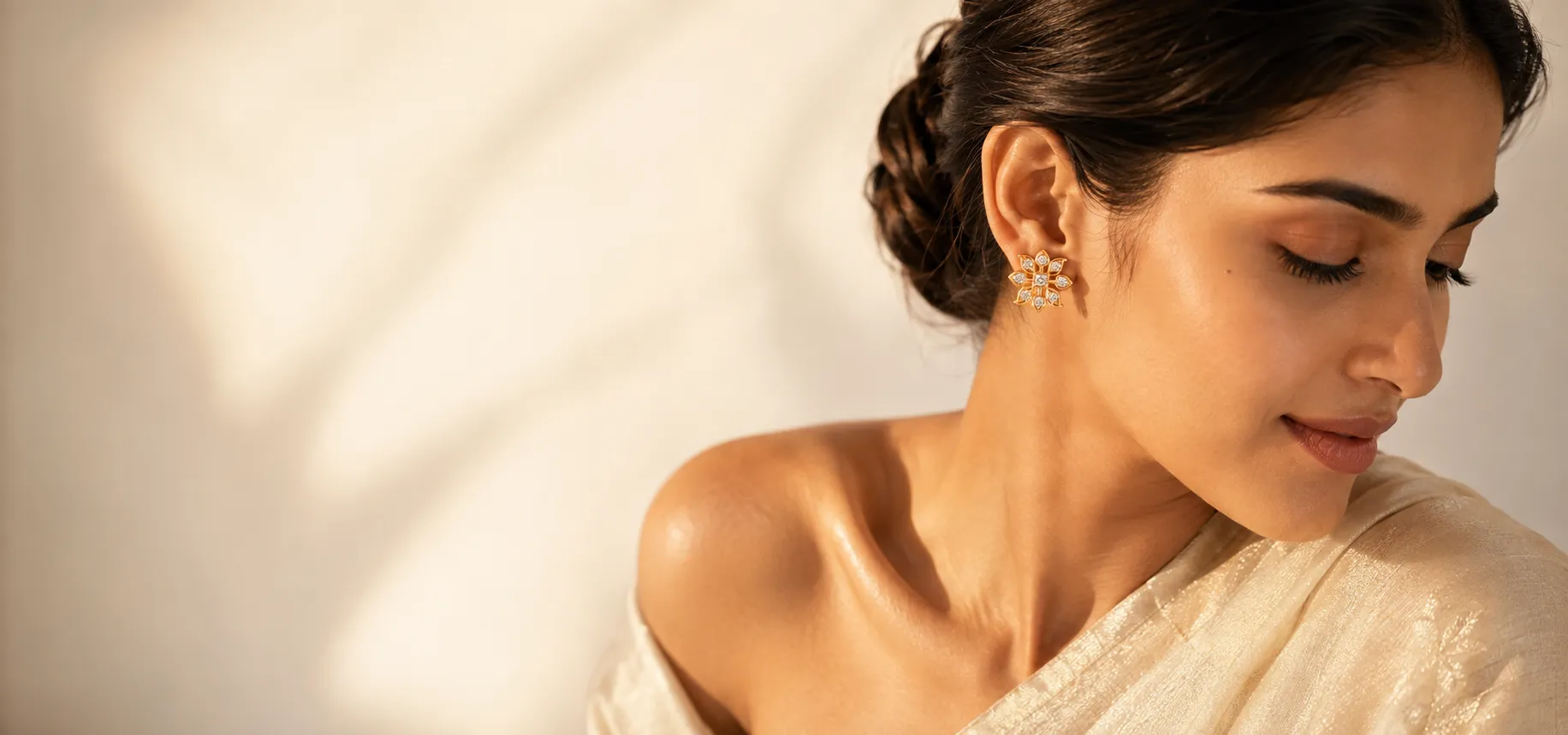 Model wearing the gold sunburst diamond stud earrings